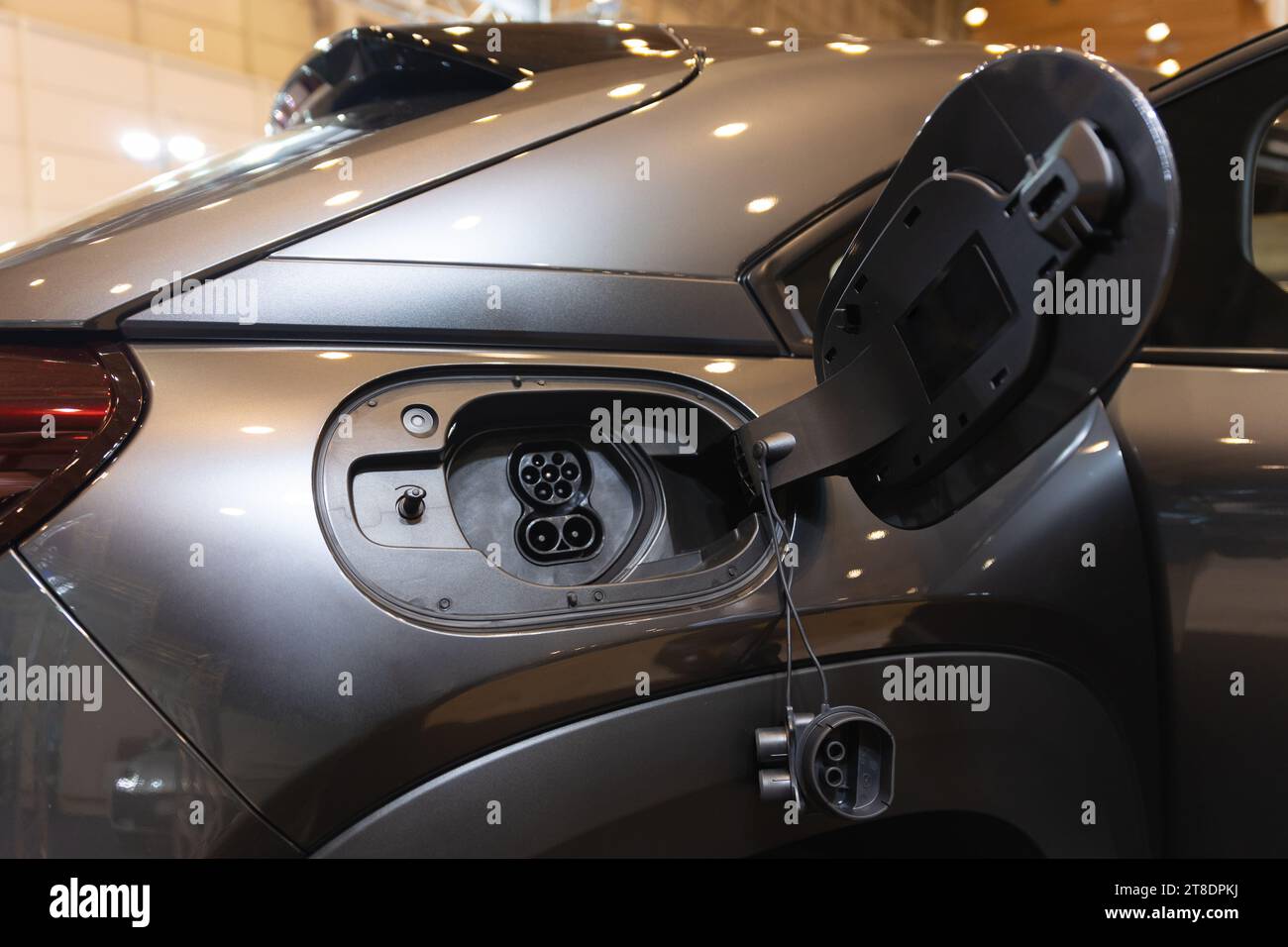 An Electric Car Being Charged at a Charging Station Stock Photo - Alamy