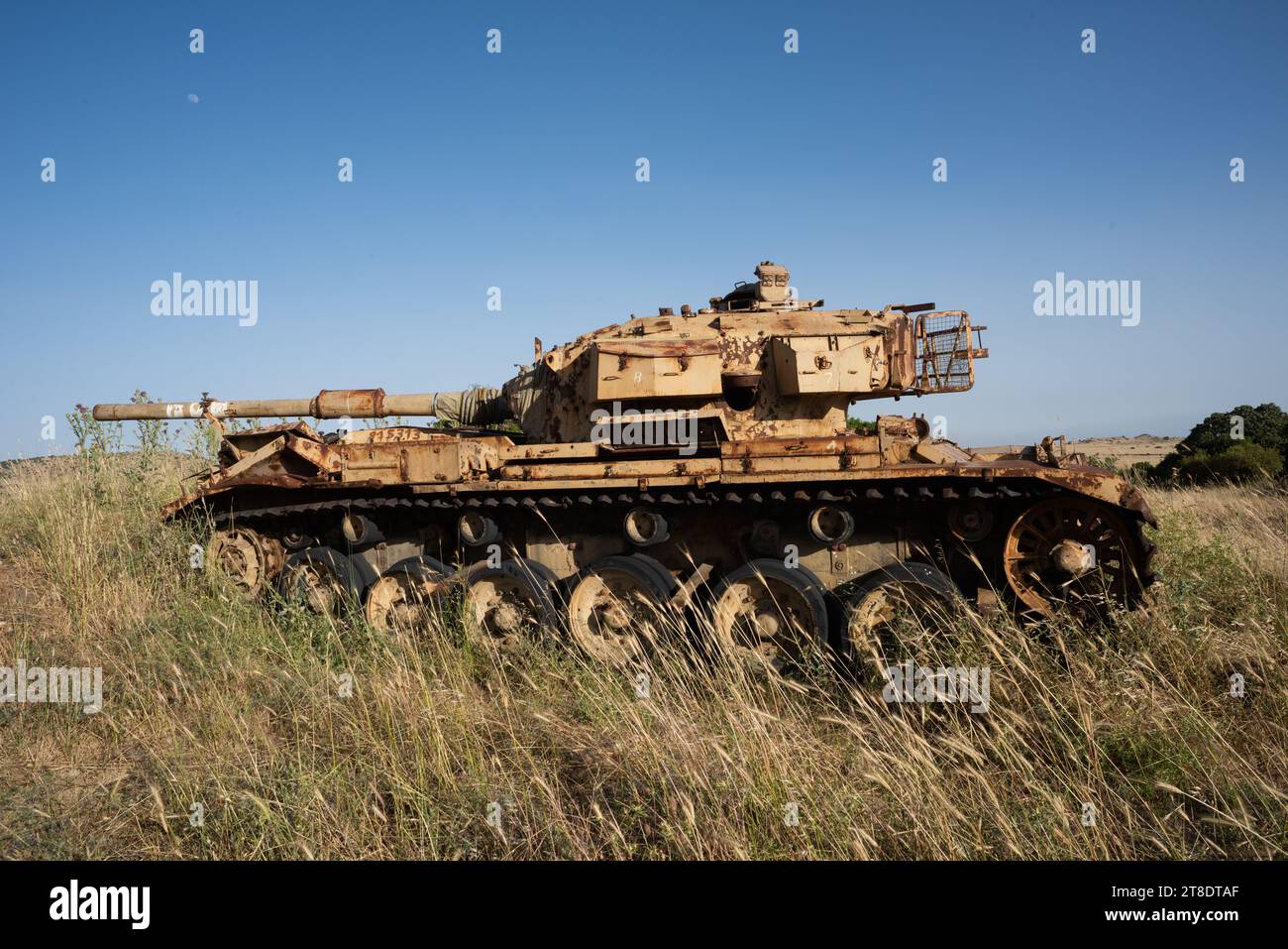 Rusted, abandoned tank from the Yom Kippur war in a meadow on the Golan Heights in northern Israel. Stock Photo