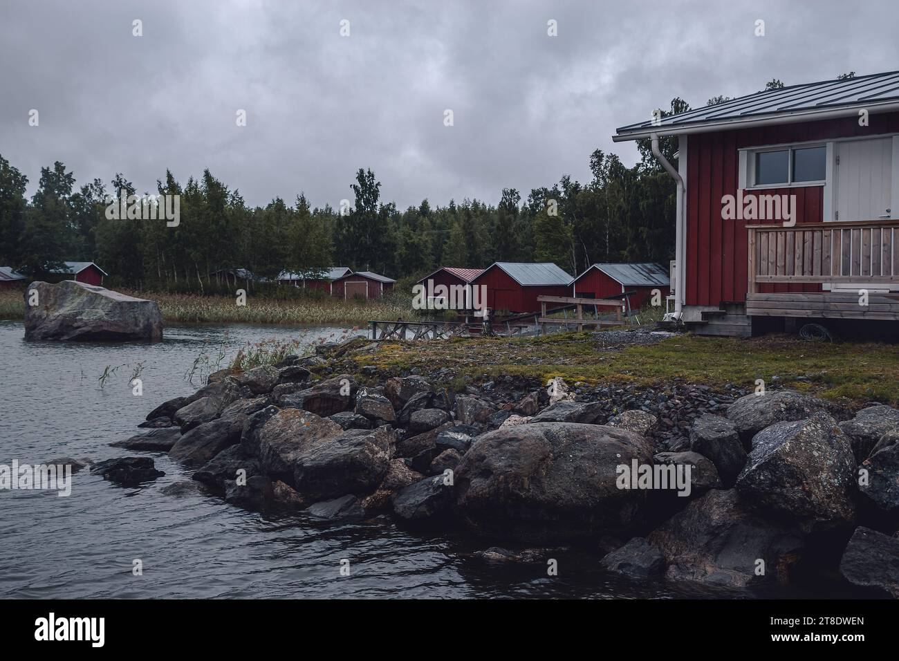 red wooden houses on the seashore in a Finnish village Stock Photo