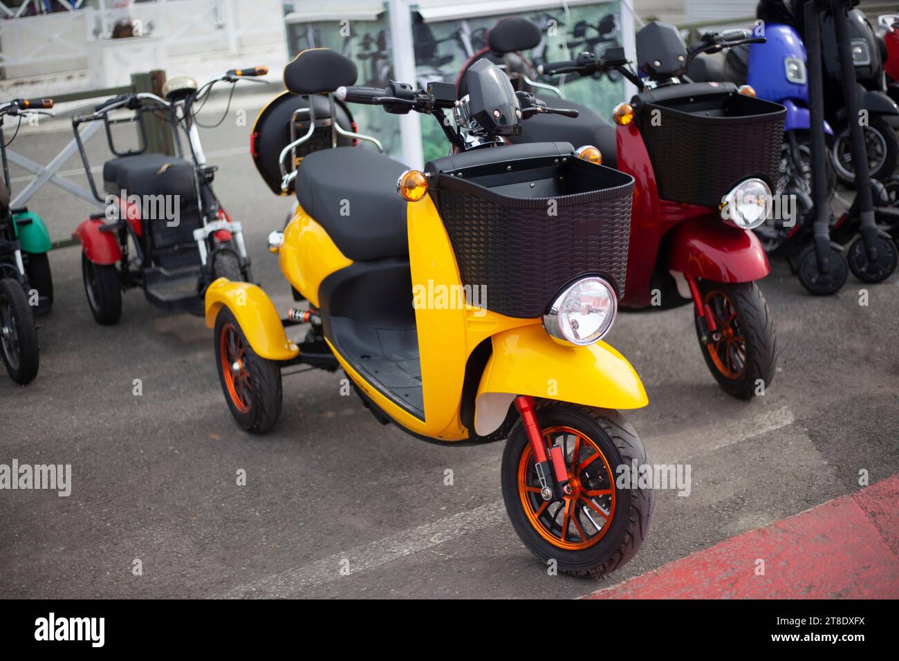 Moto electric vehicles are in a row. Electric bike rental. Headlights