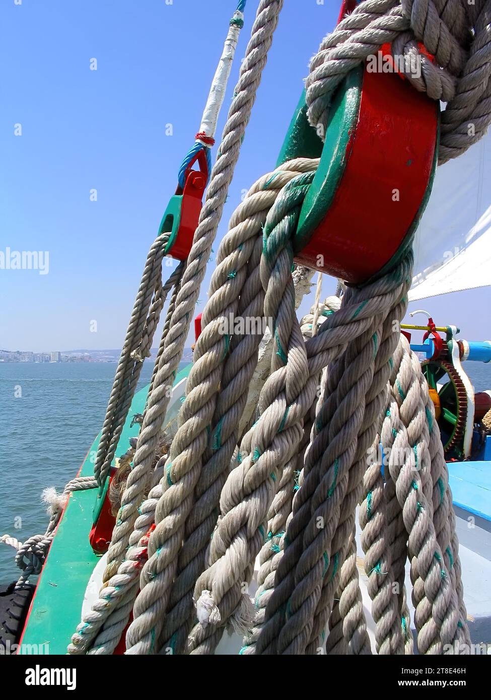 Detail of ancient pulleys and ropes or cords on the prow or bow of the sailboat Amoroso, a historical, typical or traditional Varino type Tagus river Stock Photo