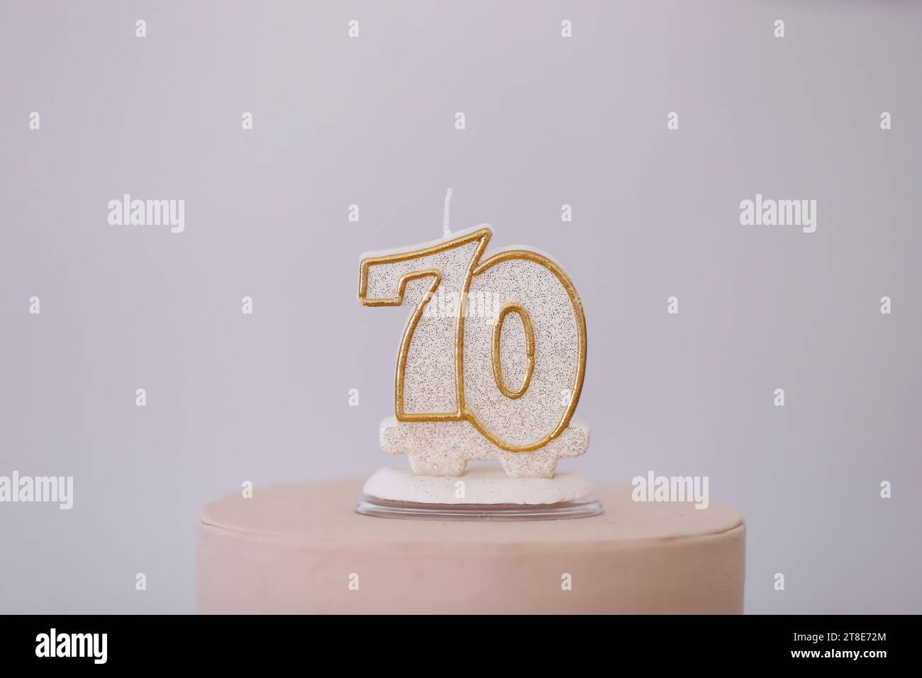 detail of the number seventy on the top of the birthday cake, 70 birthday, white cake, 70 year old birthday cake candle Stock Photo