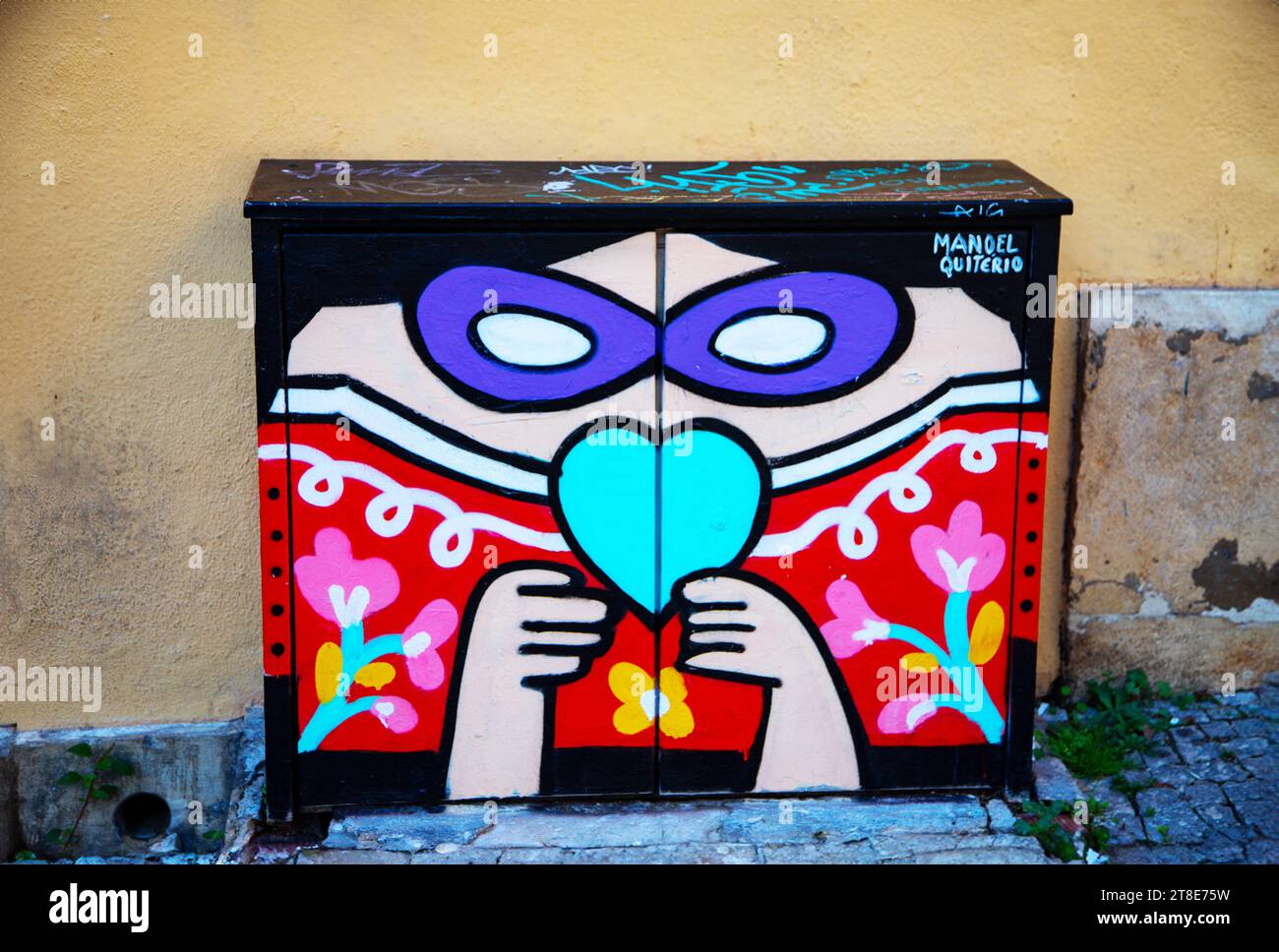 Vividly painted electrical junction box brightens Lisbon's streets, adding a pop of color amidst its charming urban landscape Stock Photo