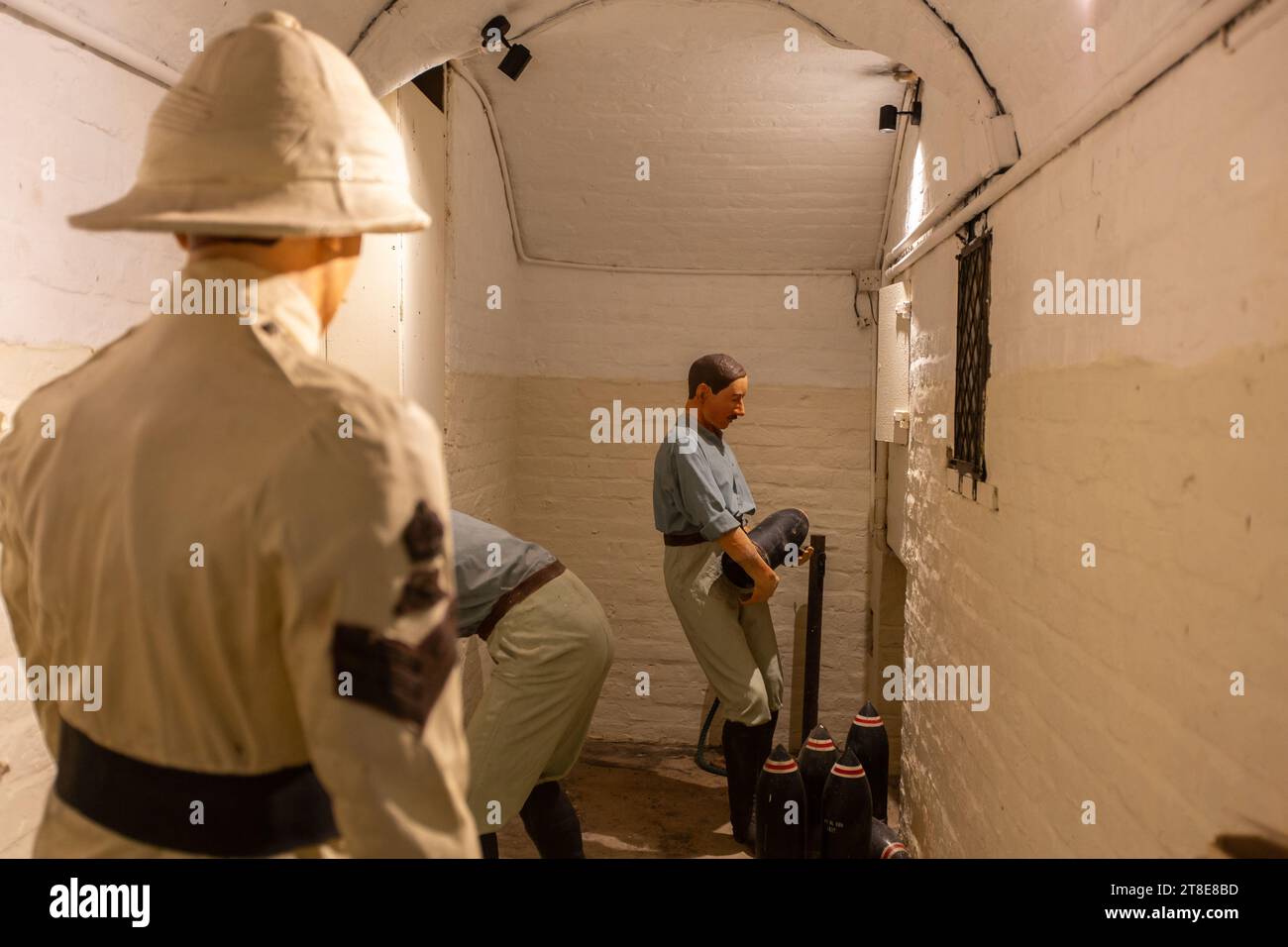A sergeant is supervising the soldiers moving the shell rounds in an ...