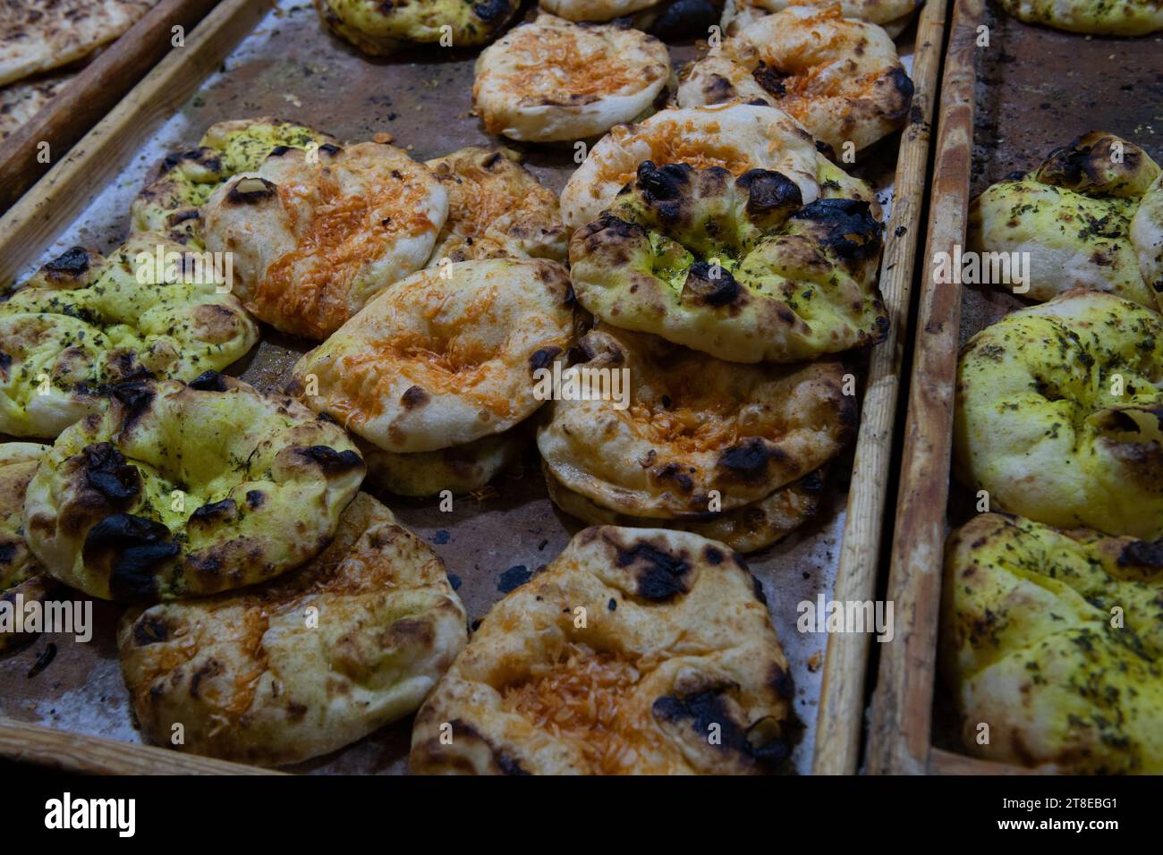 Tray of freshly-baked pita bread, seasoned with herbs and spices and sold in the Machane Yehuda market in Jerusalem, Israel. Stock Photo