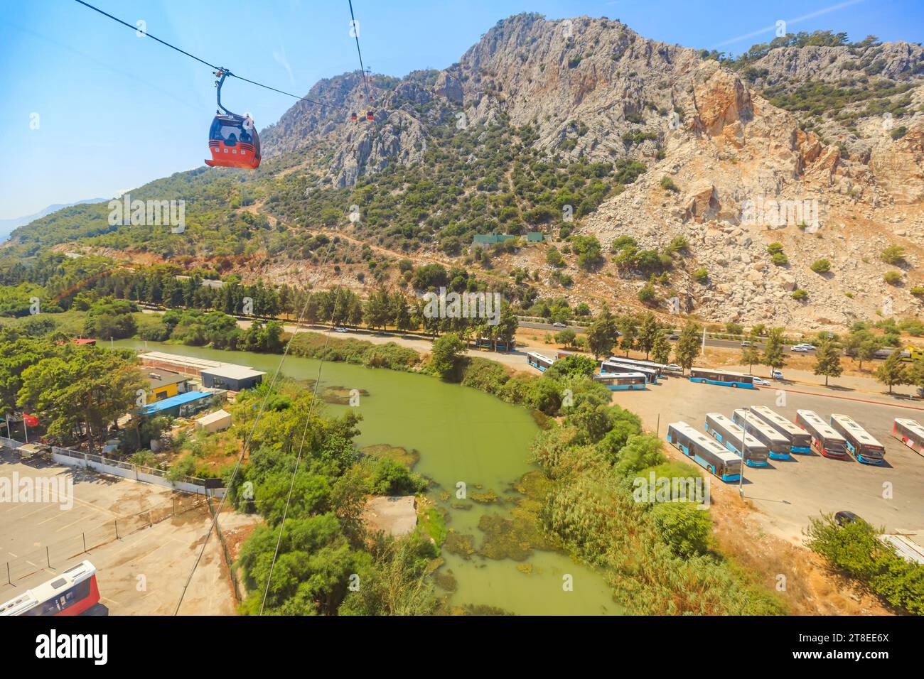 stunning landscape of Antalya, Turkey, a vibrant red cable car glides effortlessly above. Tunektepe mountain peak 605 meters above sea level, unfolds Stock Photo