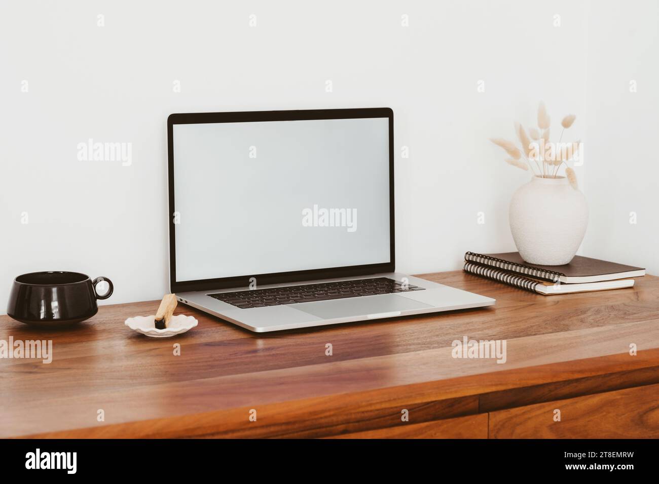 Laptop with blank screen on wooden table in home interior. Workplace ...
