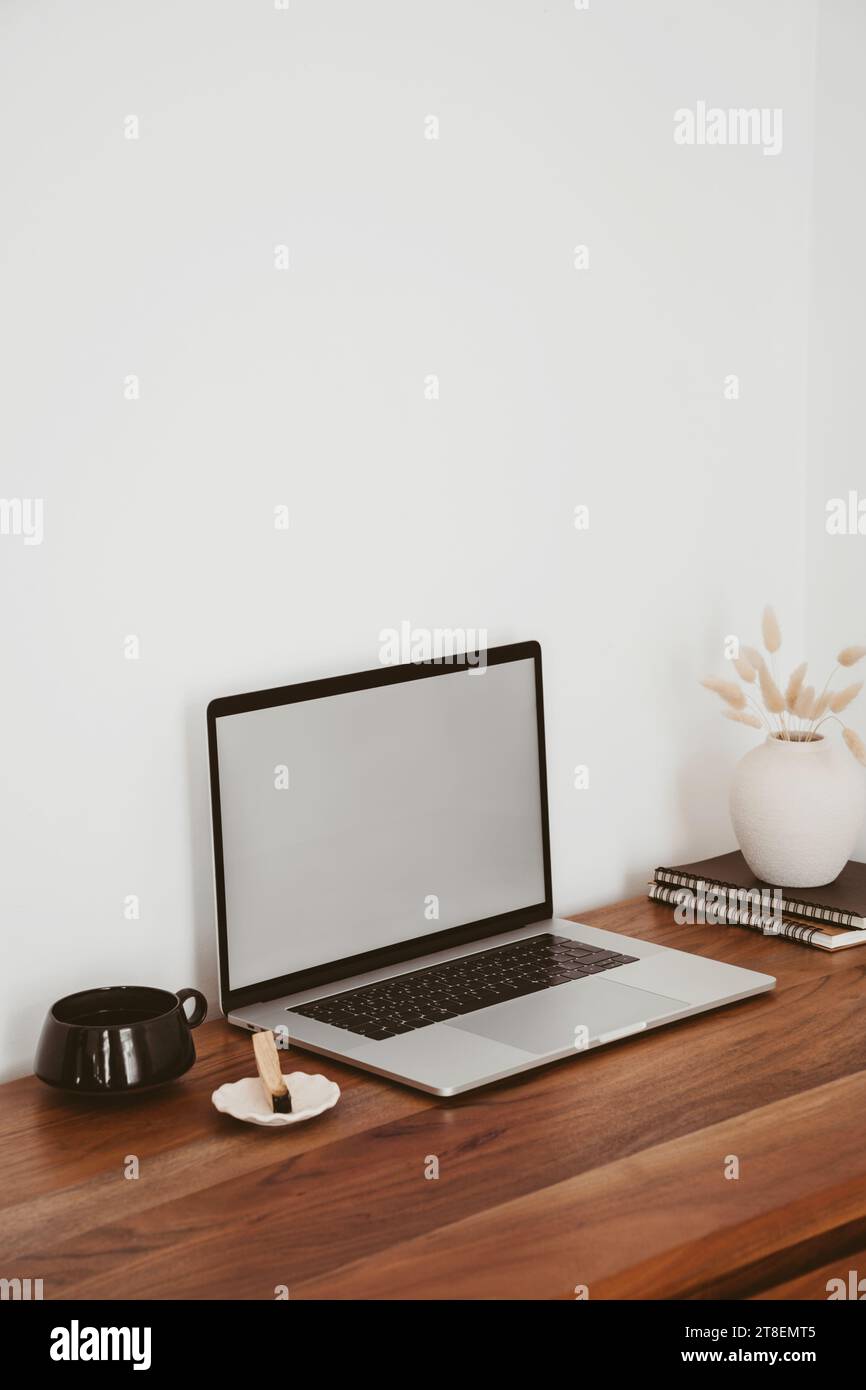 Laptop with blank screen on wooden table in home interior. Workplace ...