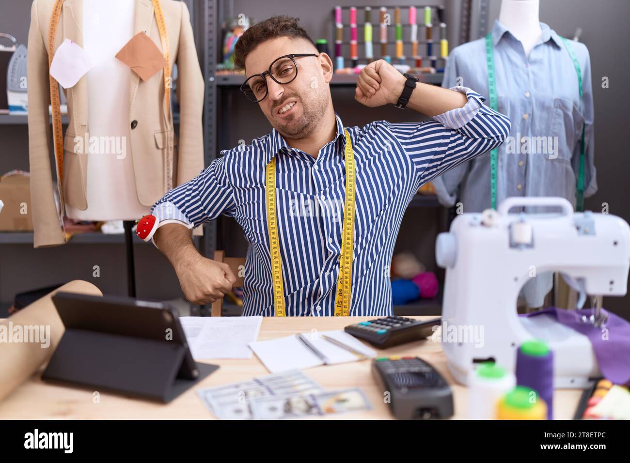 Hispanic man with beard dressmaker designer working at atelier ...