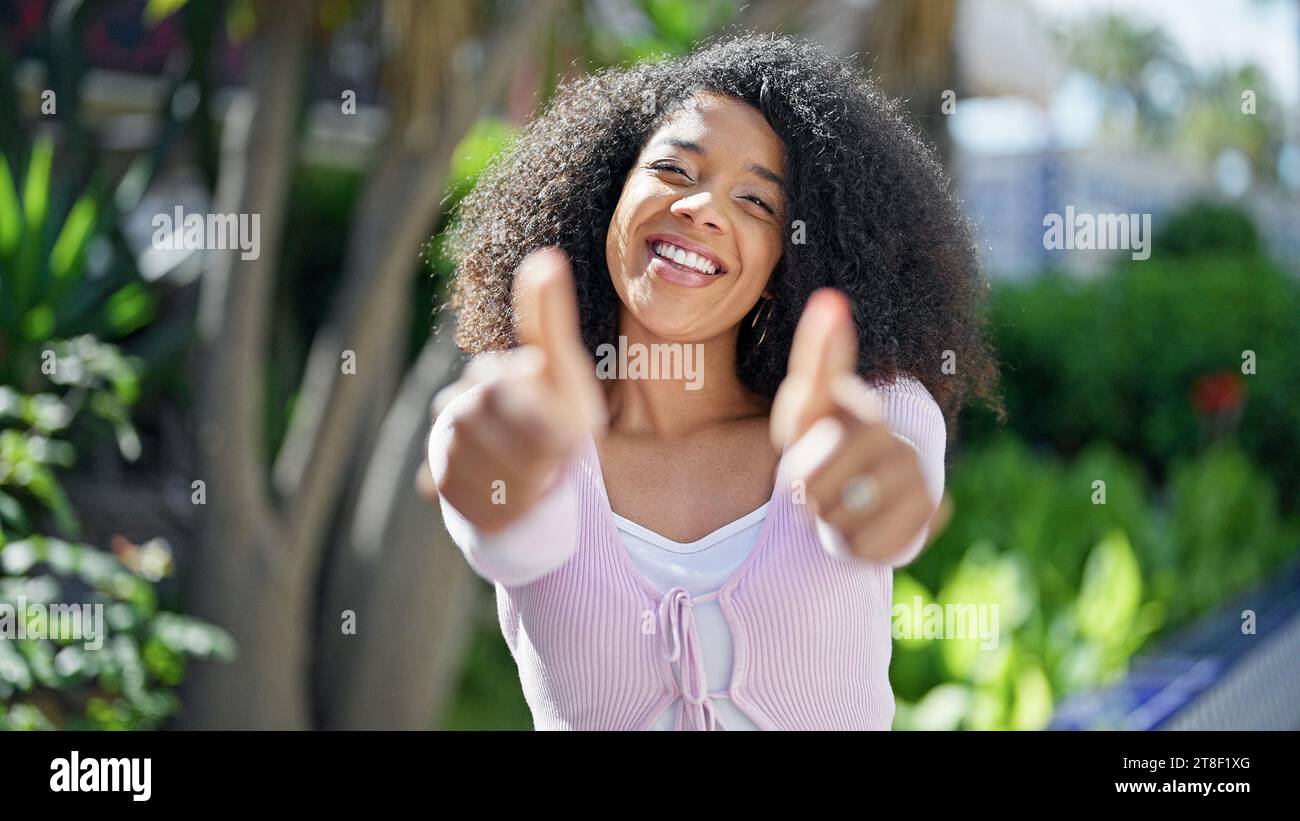 African american woman smiling confident doing ok sign with thumbs up ...
