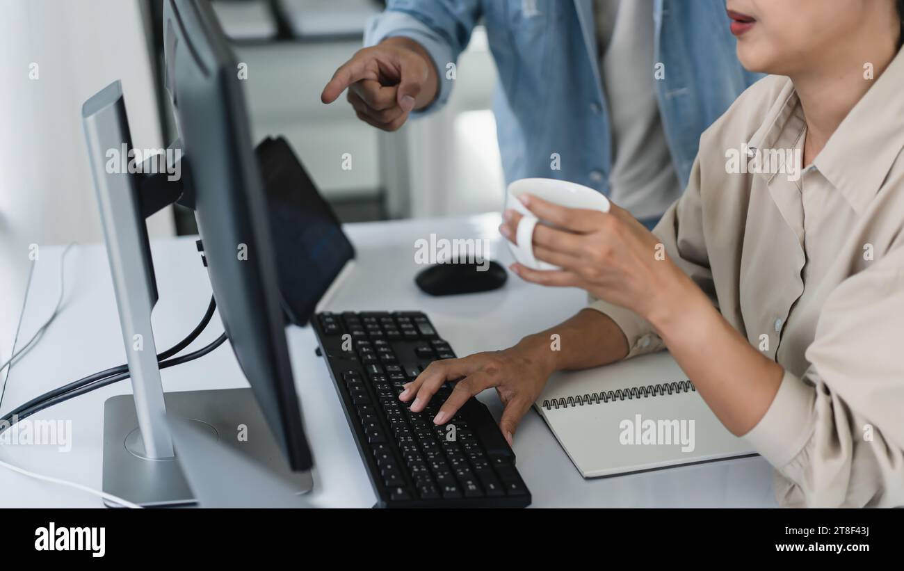 Two developer programmer discussing to checking code on monitor about programming to developing web. Stock Photo