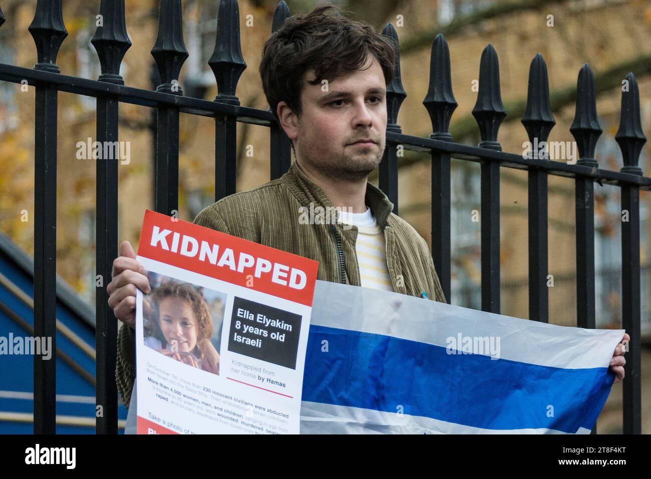 Man holding a photo of a hostage kidnapped by Hamas, 'Never Again Is ...