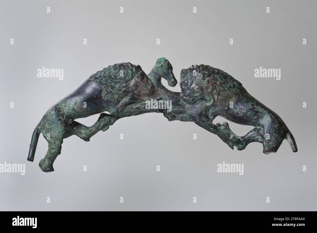 Handle from a foot bath in the shape of two lions attacking a hind, Ca. 500 BC, Container, Vessel, Handle, Height 6.3 cm, Width 15.7 cm, Metalworking, Molding, Chiseling, Greek, Archaic Period (600 BC - 480 BC Stock Photo