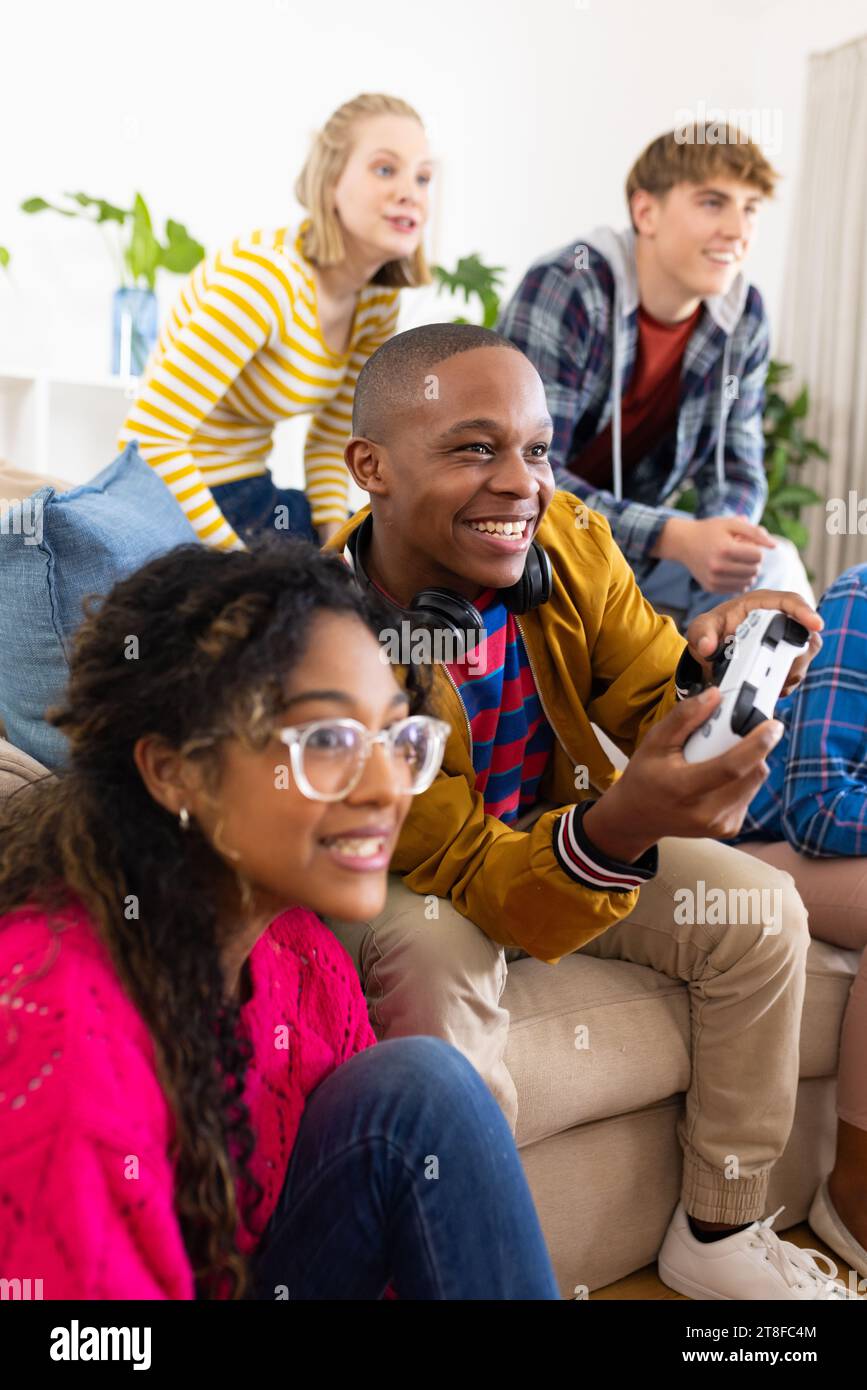 Group of diverse friends playing game on mobile phone Stock Photo