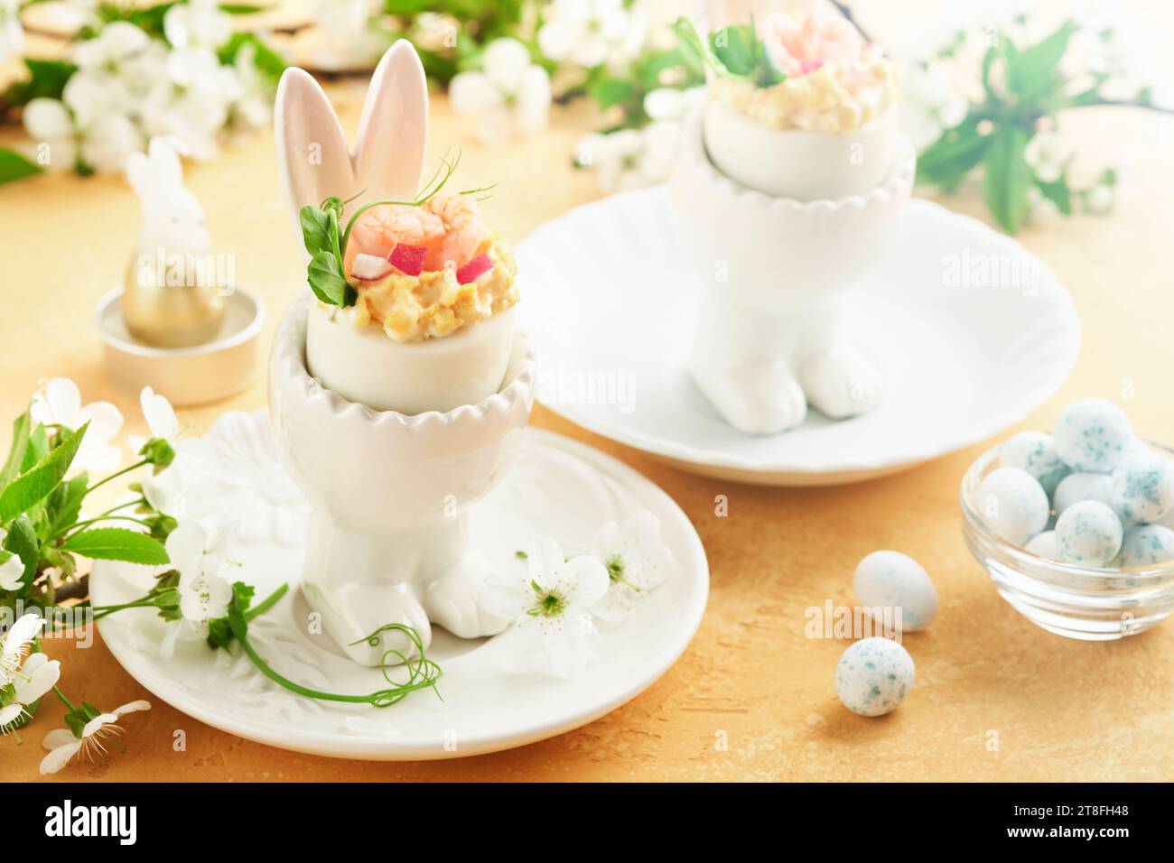 Stuffed or deviled eggs with yolk, shrimp, pea microgreens with paprika ...