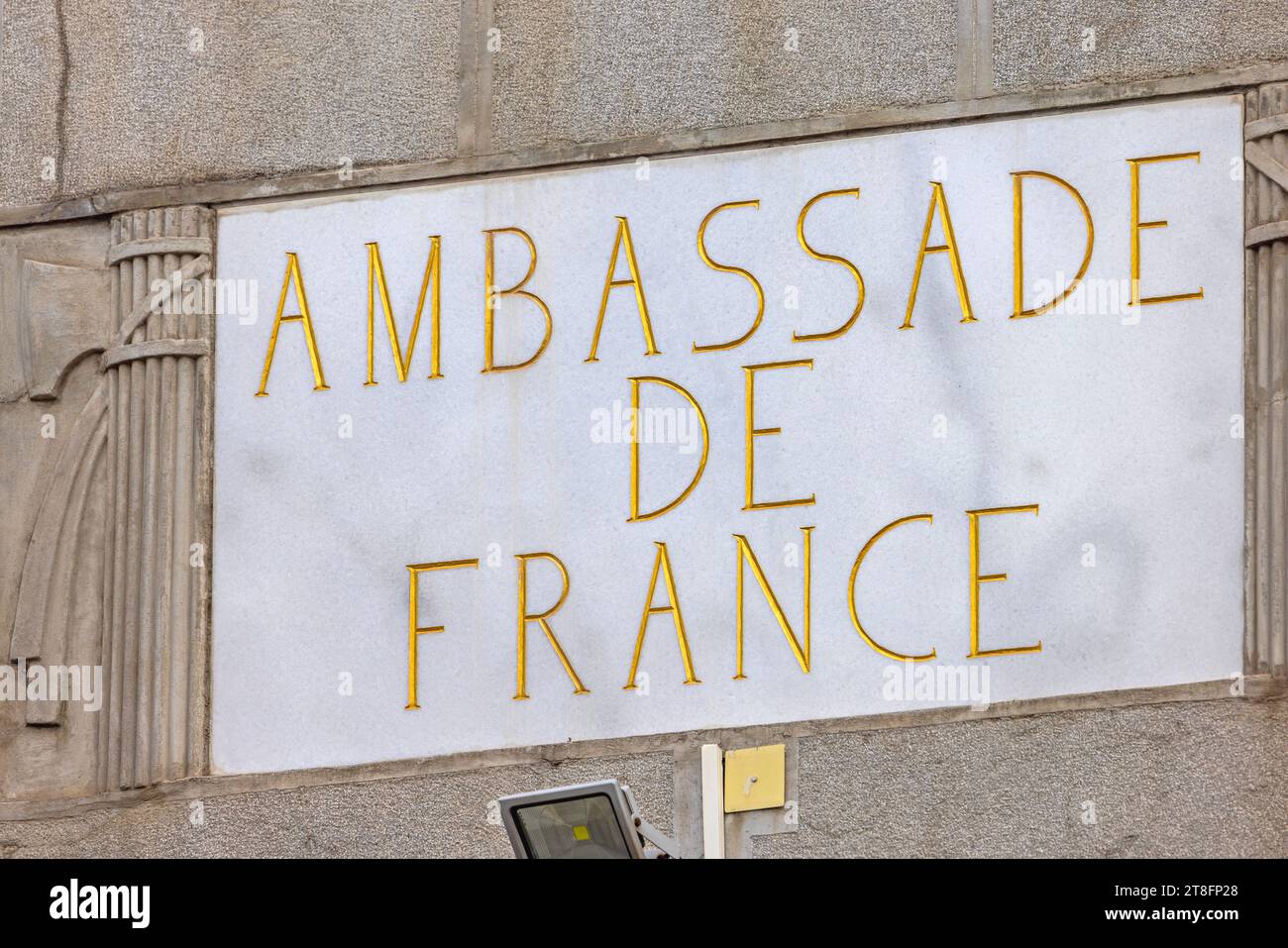 Belgrade, Serbia - September 23, 2023: Gold Letters Engraved in to White Marble Stone French Embassy Sign Ambassade de France Diplomatic Building. Stock Photo