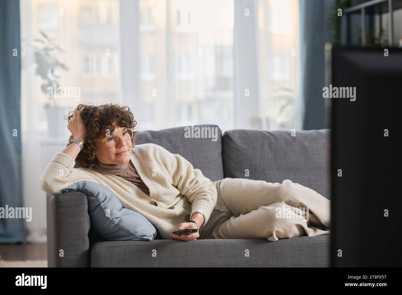 Young woman watching entertainment hi-res stock photography and images ...