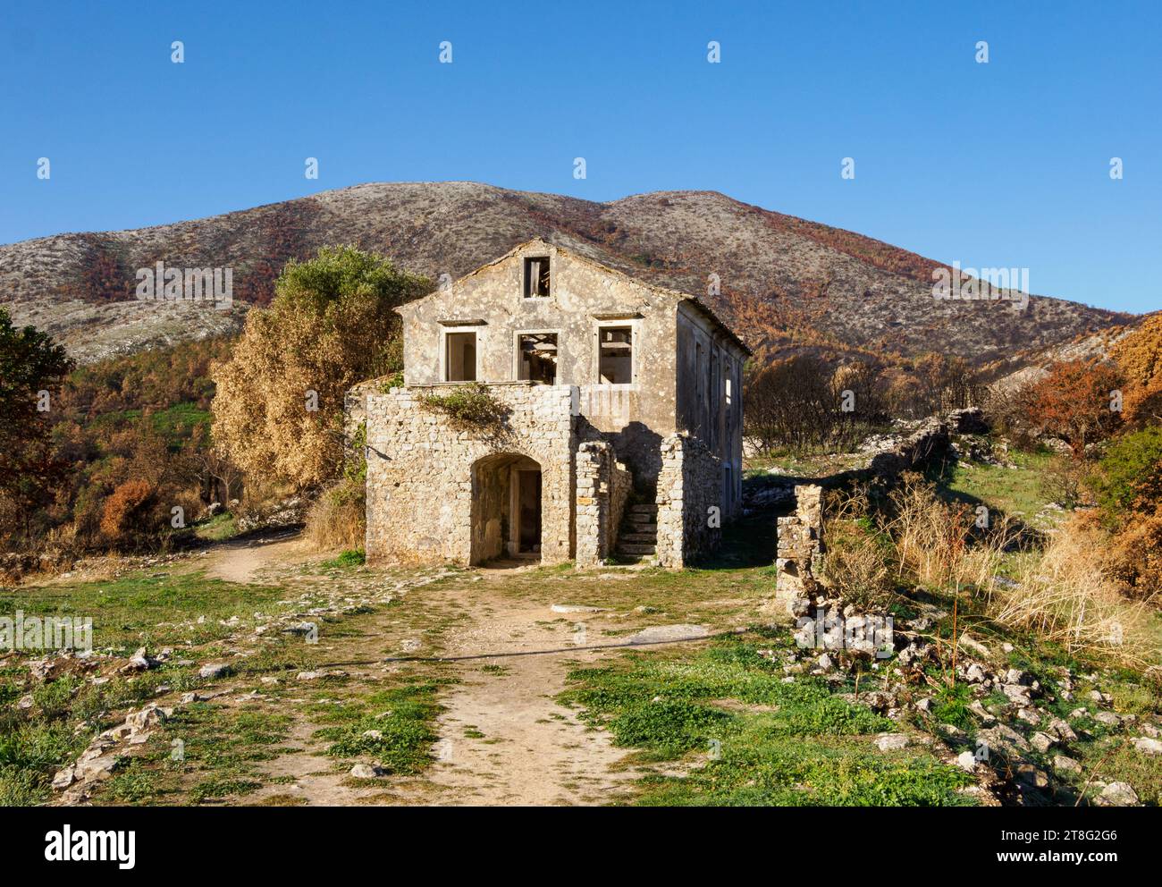 Ruined schoolhouse building in the partially abandoned village of Old Perithia (Palea Perithea) on the high slopes of Mt Pandokratoras in Corfu Greece Stock Photo