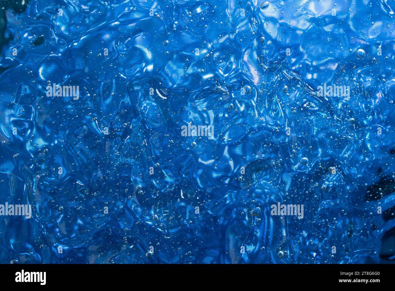 gel structure on blue background, backdrop for cosnetuc product, soft focus Stock Photo