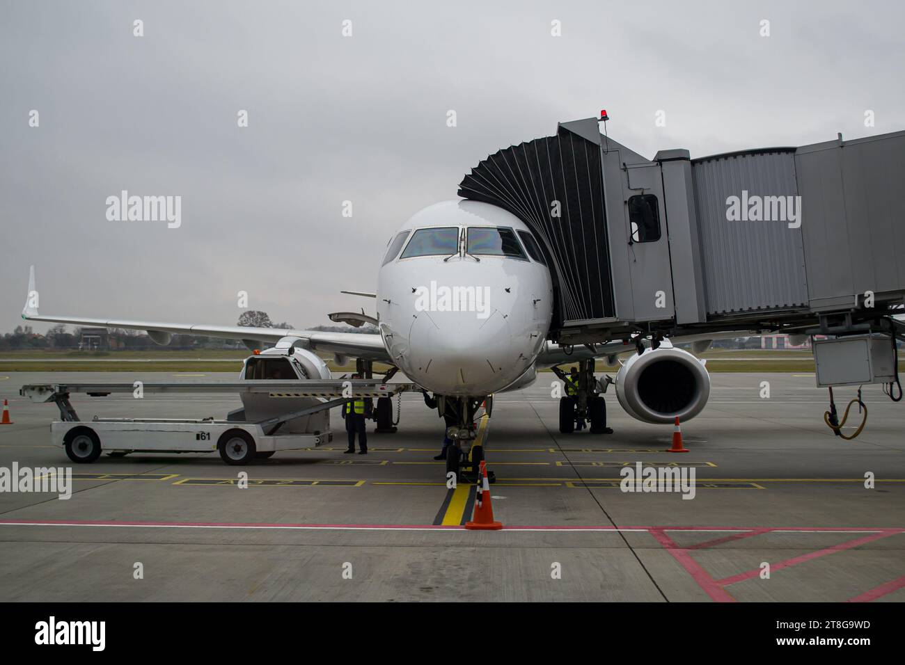 Aircraft shortly after arrival parked at the gate with an airbridge connected at Lviv Airport Stock Photo