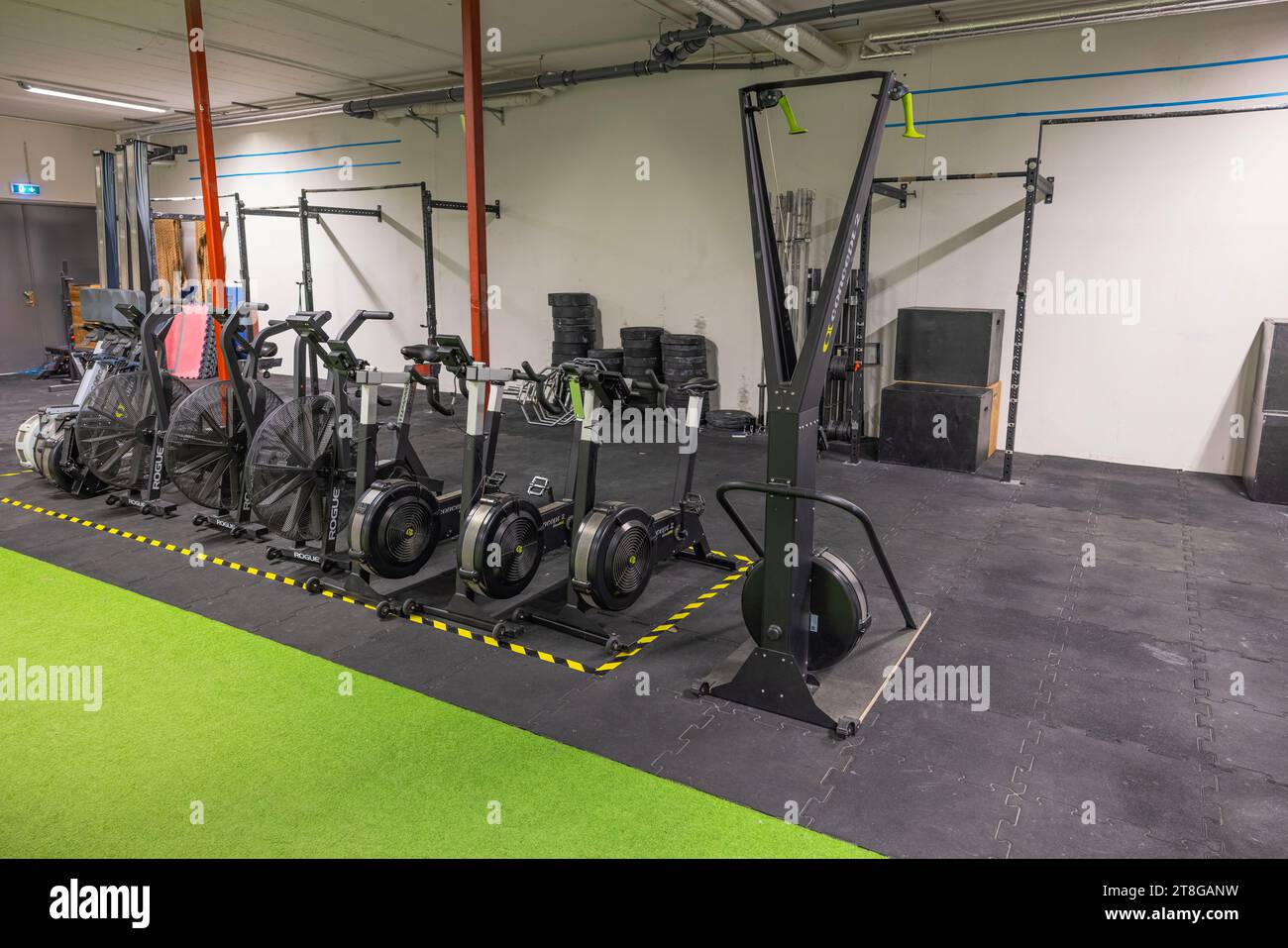 Gym with diverse equipment—strength machines, promoting healthy lifestyle. Stock Photo