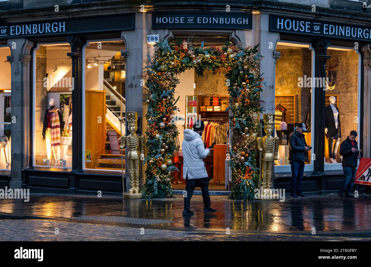 Edinburgh, Scotland, UK, 20th November 2023. The lights of Christmas decorations on a tourist shop in The Royal Mile are an attraction in the dusk light as people walk past. Credit: Sally  Anderson/Alamy Live News Stock Photo