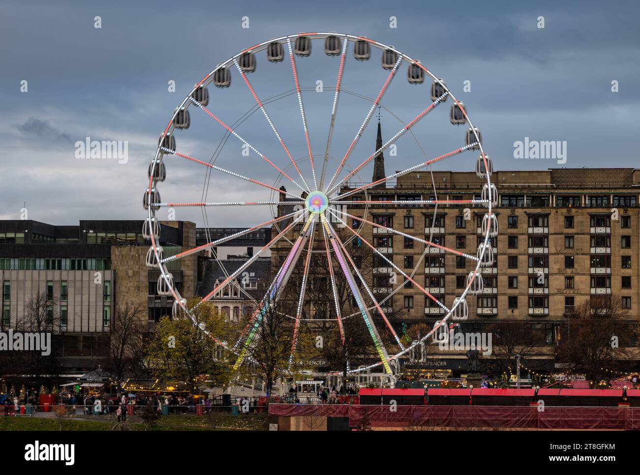 Edinburgh, Scotland, UK, 20th November 2023. The lights of Christmas decorations, Christmas market and the big ferris wheel funfair ride in Princes Street Garden are an attraction in the dusk light. Credit: Sally  Anderson/Alamy Live News Stock Photo
