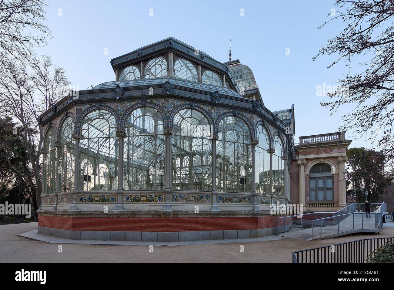 Victorian glass pavilion in a park at dusk, reflecting the twilight light. Stock Photo