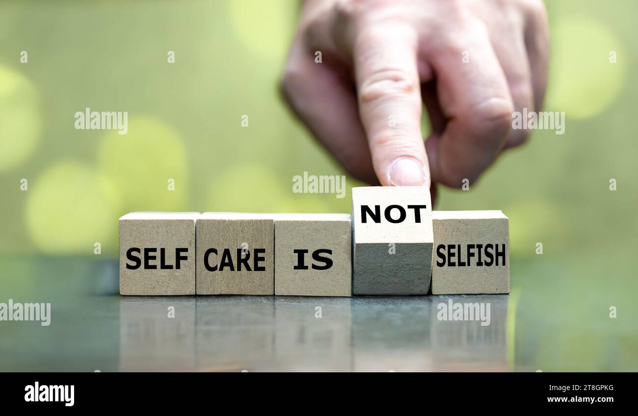 Wooden cubes form the expression 'self care is not selfish'. Stock Photo