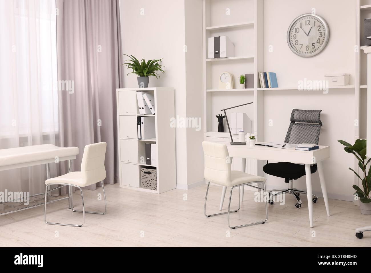 Modern medical office interior with doctor's workplace and examination ...