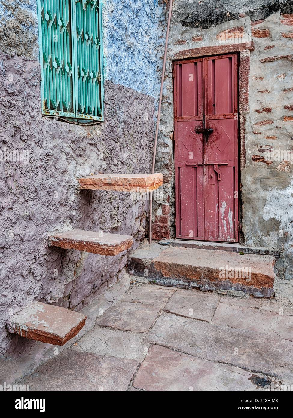 Two different kinds of stone steps lead to doors near the Toorji Ka Jhalra Bavdi step well of Jodhpur, India. Stock Photo