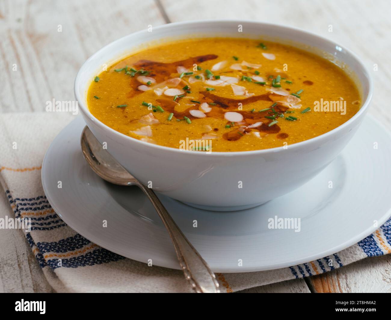 Bowl with a home made Almond, Winter Squash Bisque. Stock Photo