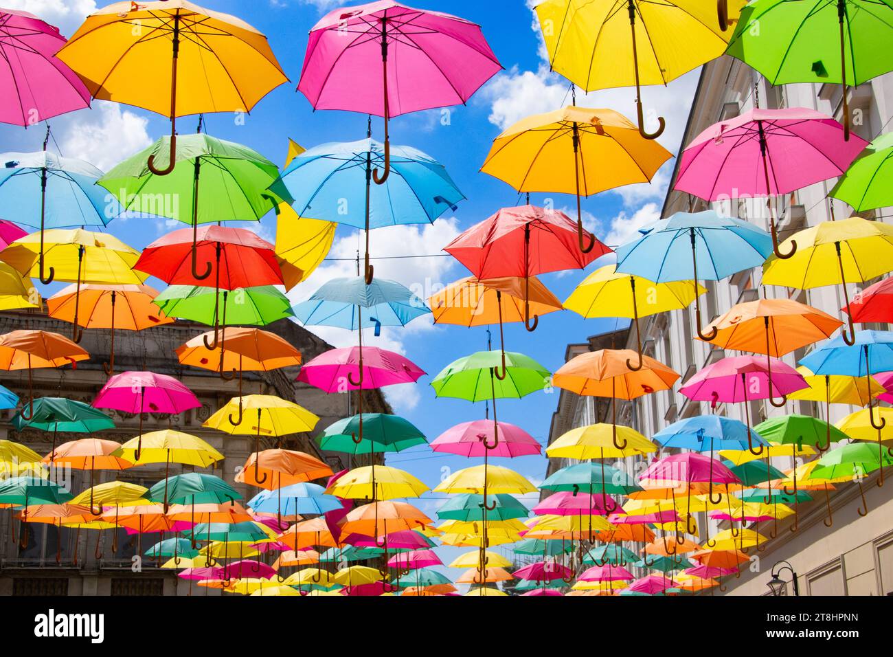 Multicolored umbrellas against a blue sky Stock Photo