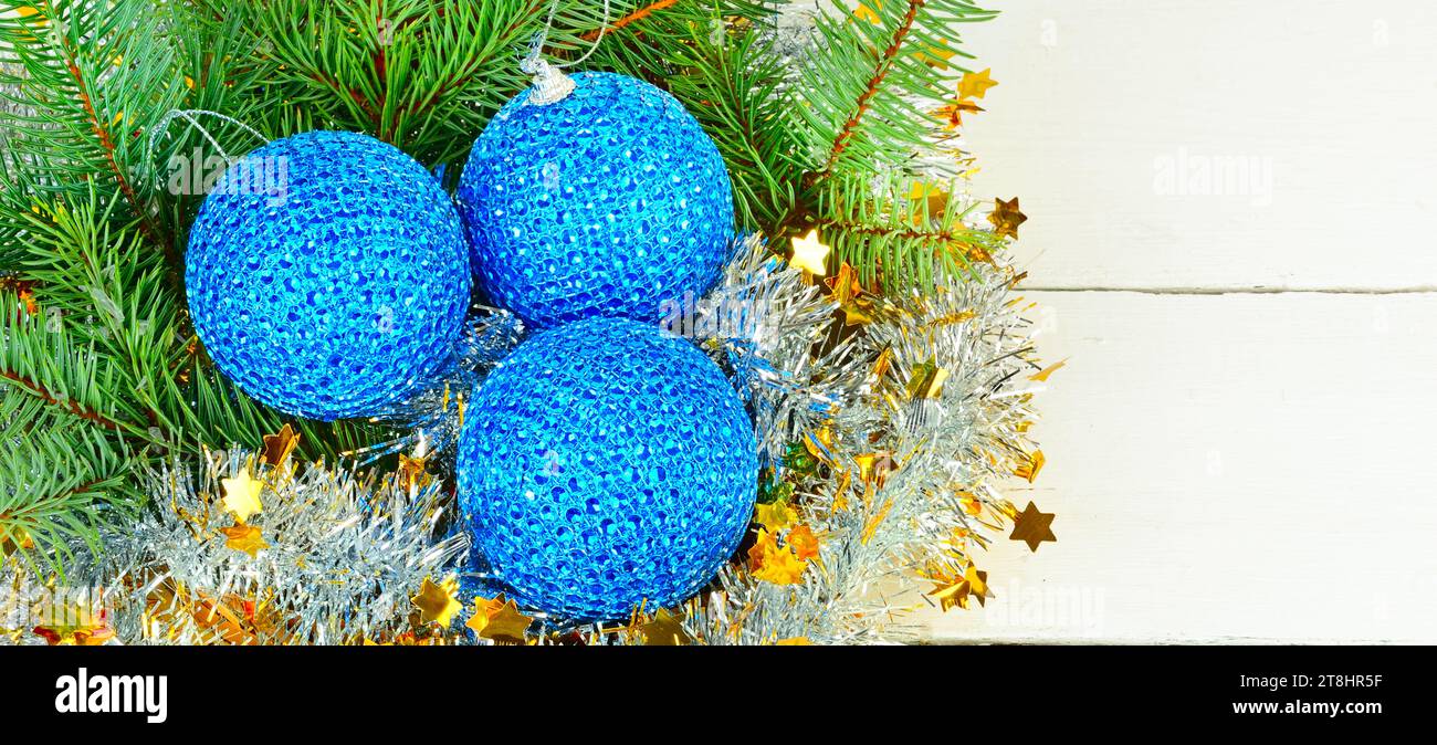 Blue Christmas balls and spruce branches on a white background. Wide ...