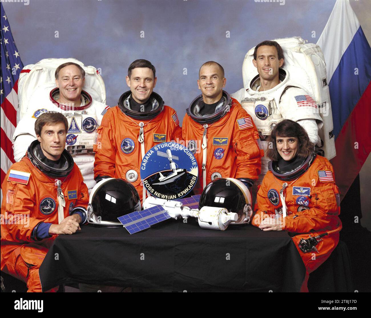 Five NASA astronauts and a Russian cosmonaut assigned to the STS-88 mission crew portrait. Seated in front (left to right) are mission specialists Sergei K. Krikalev, representing the Russian Space Agency (RSA), and astronaut Nancy J. Currie. In the rear from the left, are astronauts Jerry L. Ross, mission specialist; Robert D. Cabana, mission commander; Frederick W. “Rick” Sturckow, pilot; and James H. Newman, mission specialist. Stock Photo