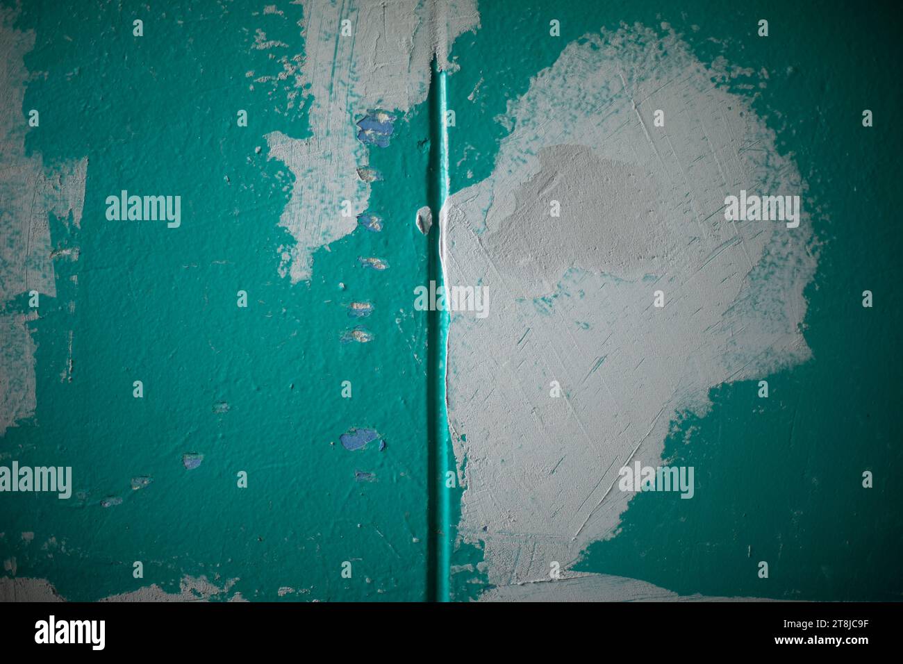 Repairing the wall. Paint on the surface. Grey Spot on Green Wall