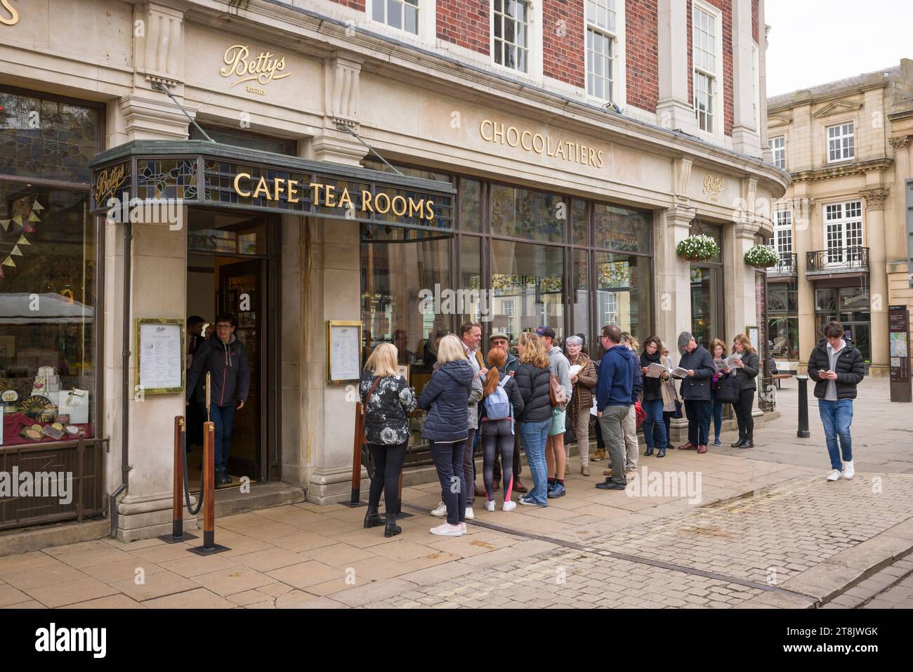 YORK, UK - April 19, 2023. People queueing outside Bettys Tea Rooms, a famous cafe in York, UK Stock Photo