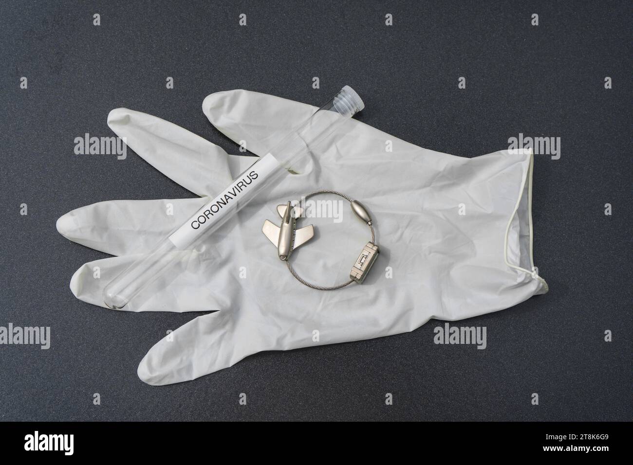 latex glove, test tubule, and luggage tag with plane, flight voyage