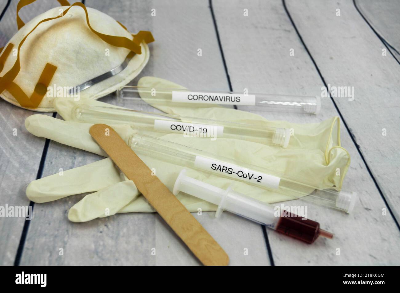 Corona test tubule, syringe, latex glove, cotton swab, mask and spatula Stock Photo