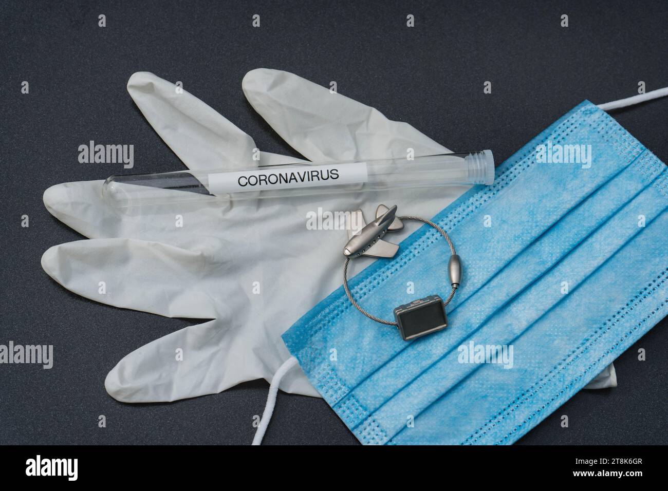 latex glove, test tubule, mask, and luggage tag with plane, flight