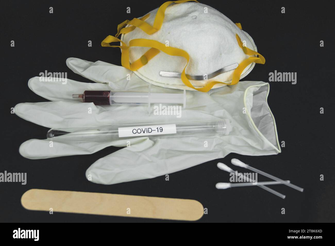 Corona test tubule, mask, syringe, latex glove, cotton swab and spatula Stock Photo