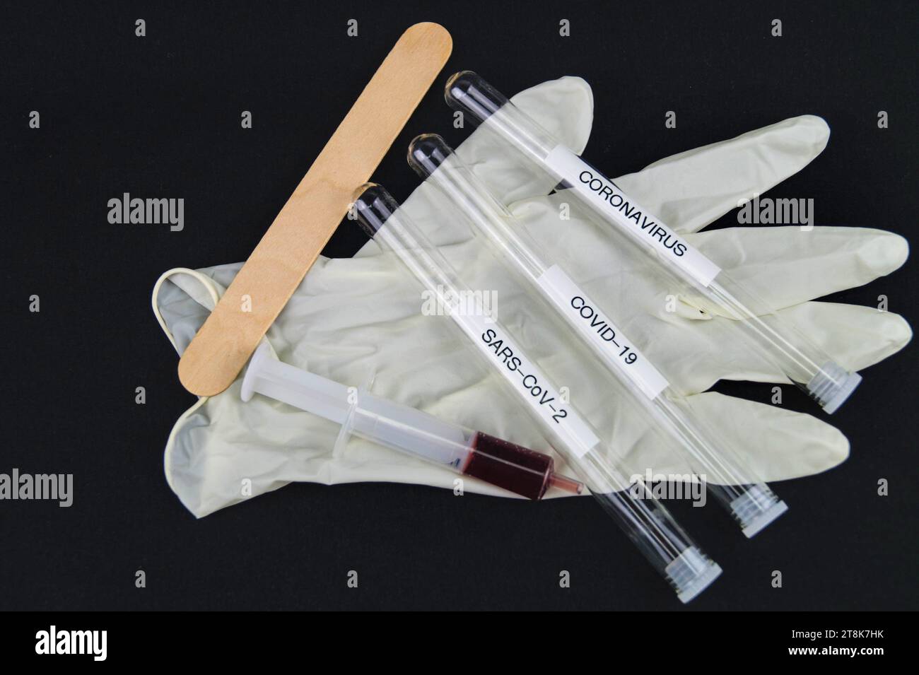 wooden spatula, latex glove, syringe and testing tubule for Corona Stock Photo