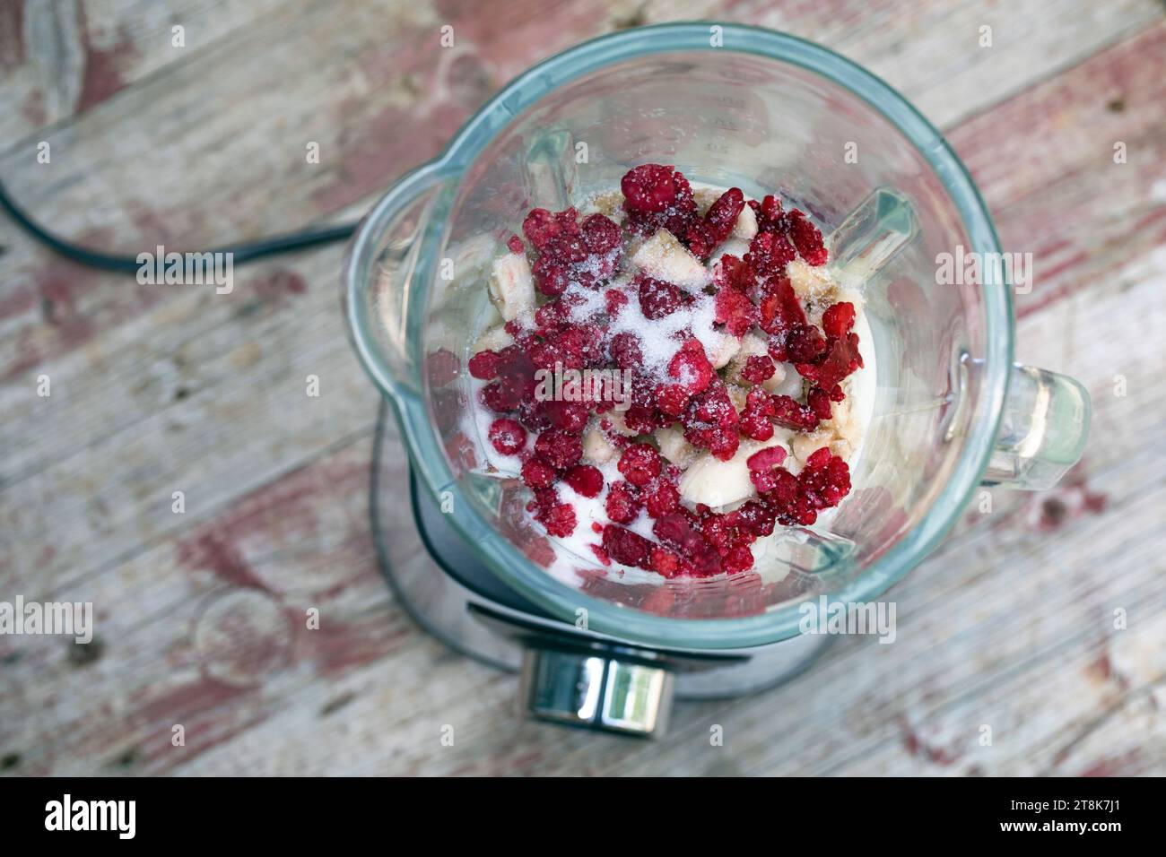 selfmade soft ice cream made of yogurt, qvark and fruits, bananas and frozen raspberries are mixed, series picture 2/4 Stock Photo