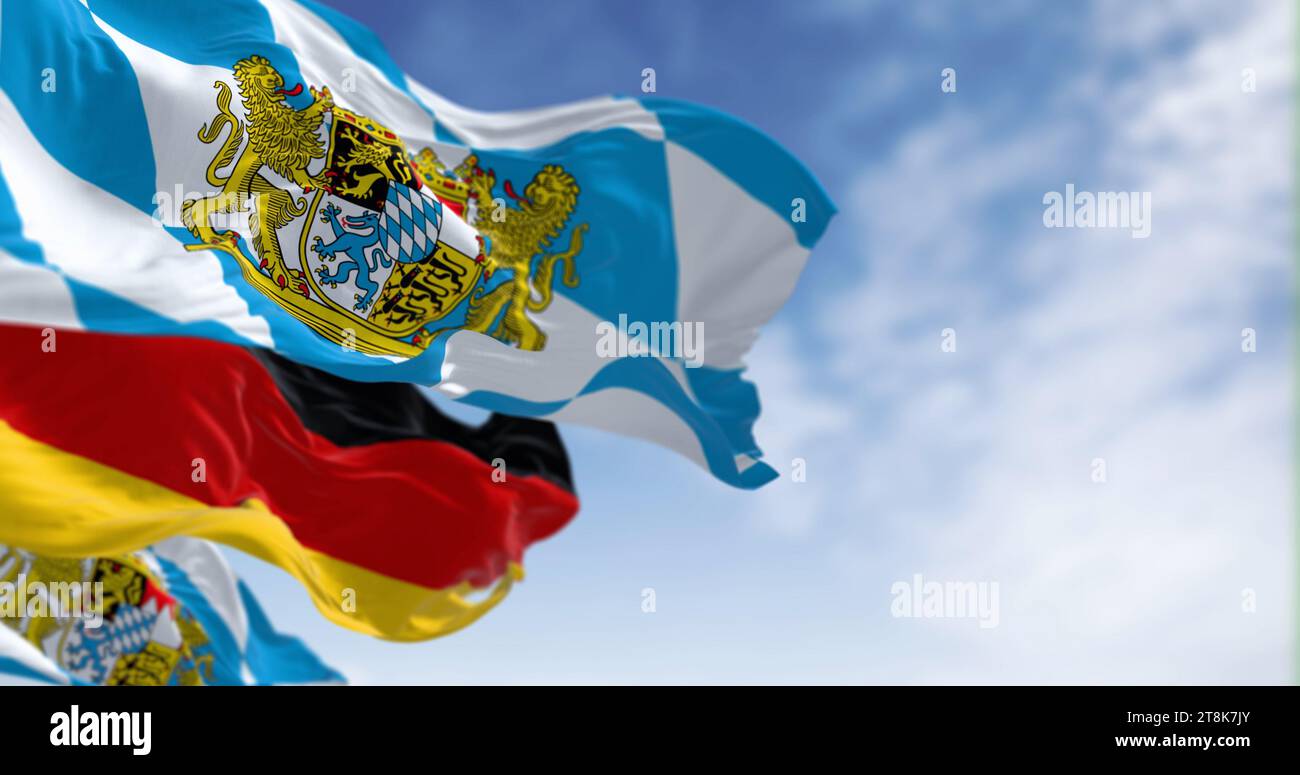 Bavarian flags waving with national german flag on a clear day. Bavaria is a state in the south-east of Germany. 3d illustration render. Selective foc Stock Photo
