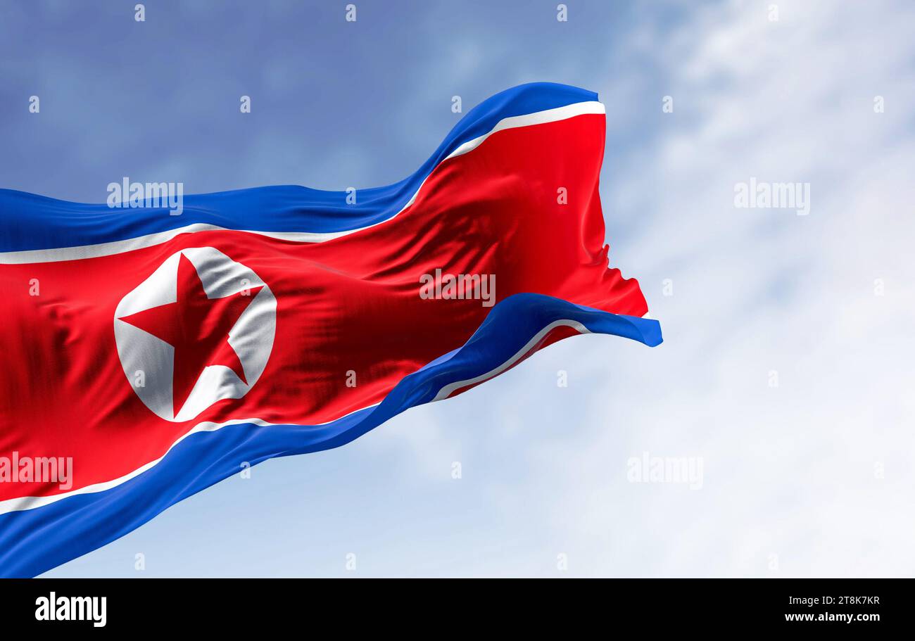 North Korea national flag waving in the wind on a clear day. Red flag with star and blue white stripes. 3d illustration render, Rippling fabric. Stock Photo