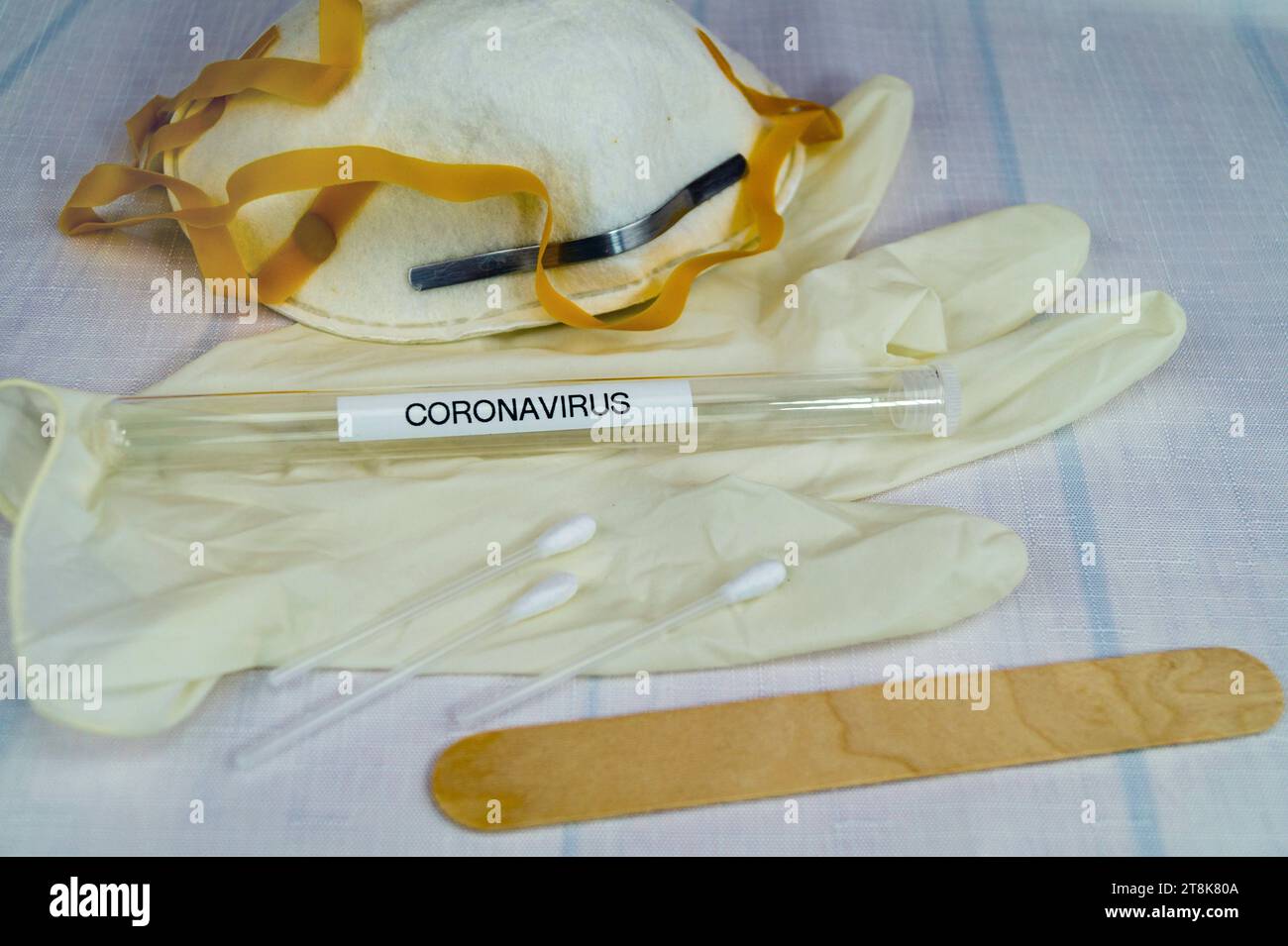 Corona test tubule, mask, latex glove, cotton swab and spatula Stock Photo