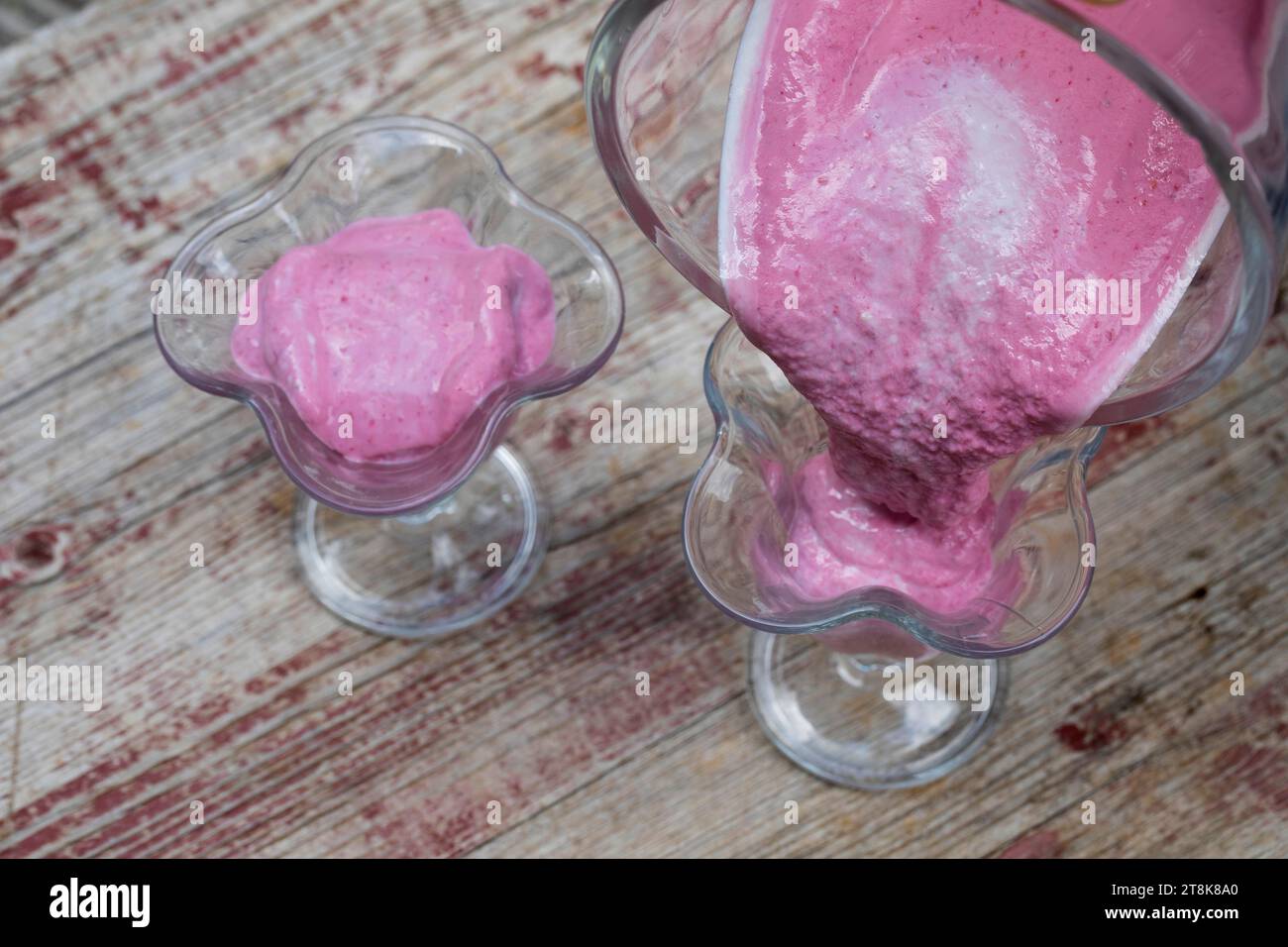 selfmade soft ice cream made of yogurt, qvark and fruits, bananas and wild raspberries are mixed, series picture 3/4 Stock Photo