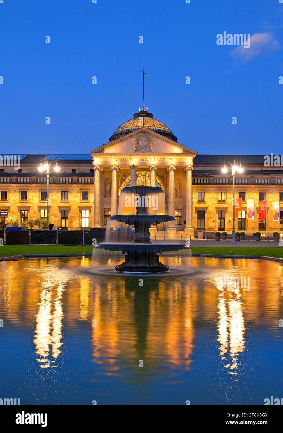 Illuminated Kurhaus and casino with cascading fountain in the evening , Germany, Hesse, Wiesbaden Stock Photo