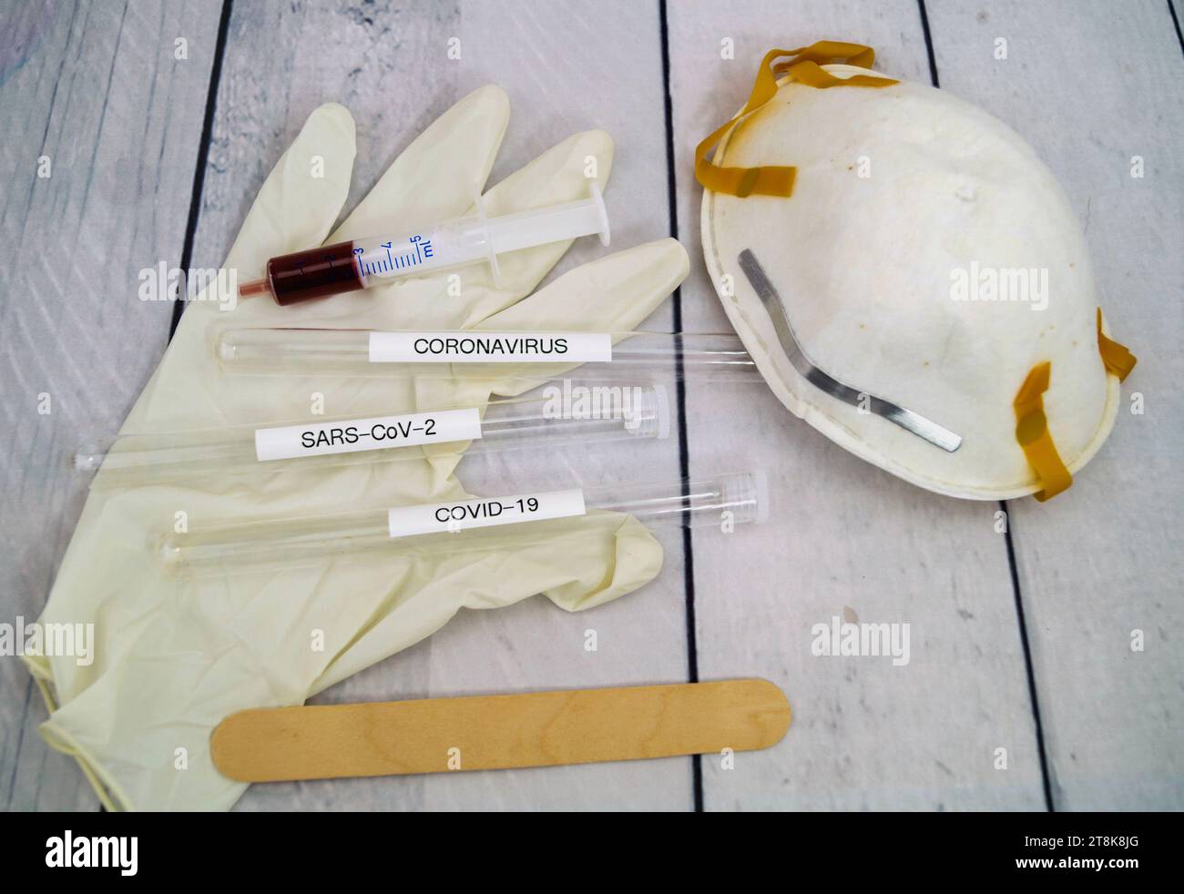 Corona test tubule, syringe, latex glove, cotton swab, mask and spatula Stock Photo
