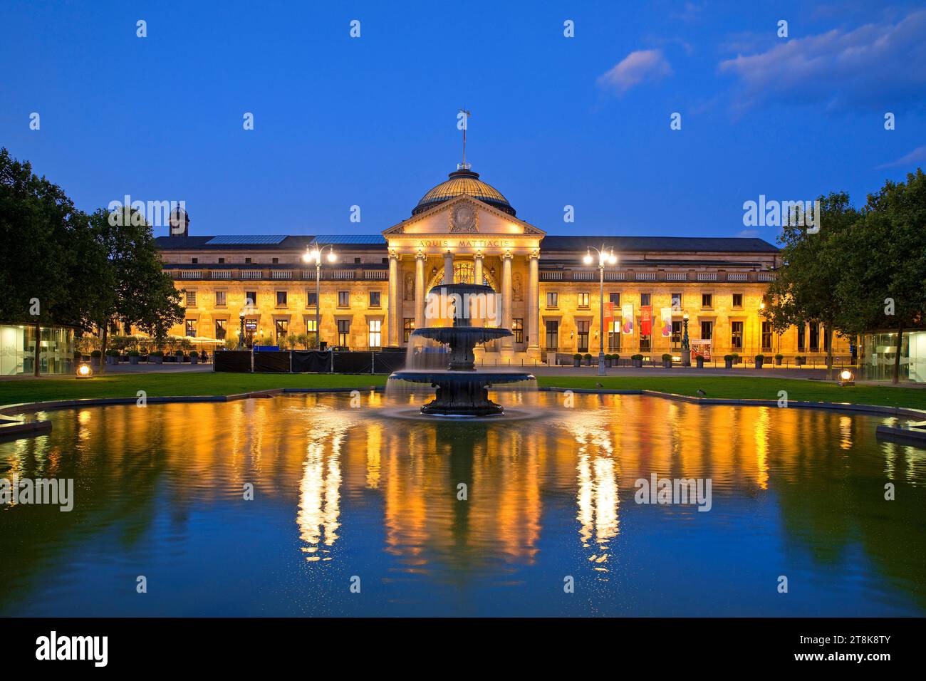 Illuminated Kurhaus and casino with cascading fountain in the evening , Germany, Hesse, Wiesbaden Stock Photo